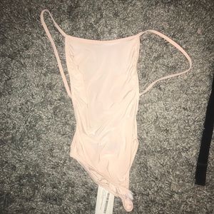 Pink/tan right body suit open in the back